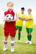 Football player wearing a pig's mask as his rivals looks at him