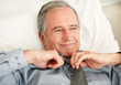 Relaxed senior business man loosening his tie