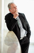 Photo: Thoughtful mature business man with hand on chin Thoughtful mature business man with hand on chin