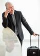 Photo: Happy man with his luggage and talking over the cell phone Happy man with his luggage and talking over the cell phone