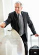 Photo: Happy senior business man shaking hand at the hotel reception Happy senior business man shaking hand at the hotel reception
