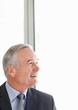 Happy senior business man looking at copyspace