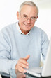 Happy mature man working on a laptop