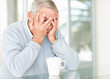 Frustrated senior man with hands on face