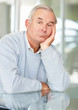 Stressed senior man with hand on chin