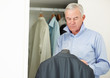 Senior business man trying to choose the right suit