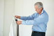 Senior business man trying to choose the right tie for his shirt
