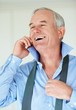 Laughing senior business man over a cellphone