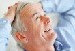 Relaxed senior business man with hands behind head
