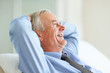 Laughing mature business man with hands behind head