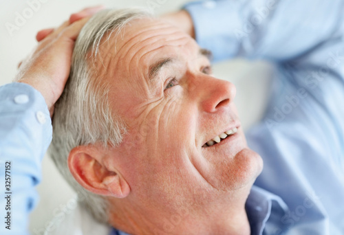 Photo: Relaxed senior business man with hands behind head Relaxed senior business man with hands behind head