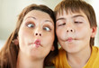 Middle aged woman with her son making a funny faces
