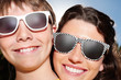 Photo: Happy mature woman with her son wearing sunglasses Happy mature woman with her son wearing sunglasses