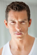 Photo: Young Caucasian man against grey background Young Caucasian man against grey background