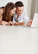 Foto: Father showing something interesting to his daughter on laptop Father showing something interesting to his daughter on laptop