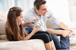 Foto: An excited little girl playing a video game with her father An excited little girl playing a video game with her father