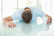 Middle aged man sleeping while holding a cup of coffee or tea