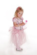 mischievous little girl in pink fairy dress
