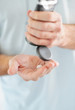 Man's hand preparing to apply cream