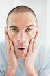 Closeup of a middle aged man uses a lotion after shaving