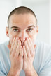 Middle aged man applying after shave lotion