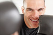 Cheerful man wearing boxing gloves smiling