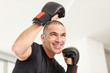Smiling middle aged boxer ready for a fight