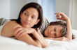 Mature couple lying in bed with sad expressions