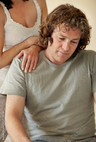 Foto: Mature woman consoling a tensed middle aged man Mature woman consoling a tensed middle aged man