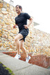 Young male athlete runnig on stairs - outdoor