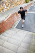 Young male jogger runnig on stairs outdoor