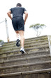 Young male jogger running on stairs outdoor