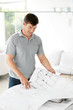 handsome young man looking at blue prints and diagram
