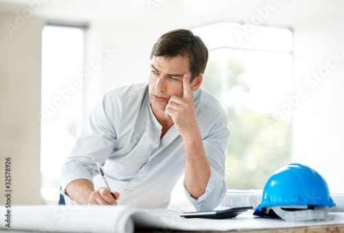 Photo: Handsome young male civil engineer thinking Handsome young male civil engineer thinking