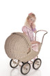 Photo: little girl dressed playing with baby carriage little girl dressed playing with baby carriage