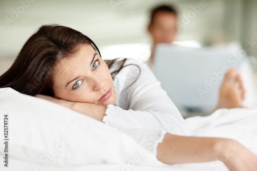 Photo: Lady lying on bed and looking at you Lady lying on bed and looking at you
