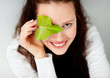 Save the nature - Young woman holding a leaf