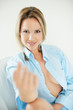 Alluring woman in blue shirt gesturing an invitation