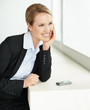Happy business woman looking away in thoughts