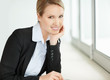 Successful business woman smiling with hand on chin