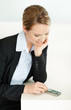 Young Caucasian business lady looking at her mobile phone