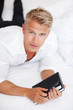 Man lying in bed with diary and pen