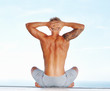 Man meditating with hands behind head