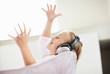 Joyful girl wearing headphone and listening music