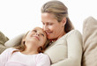 An innocent girl resting on caring mature woman