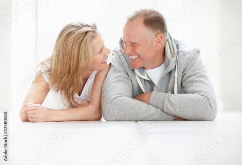 Photo: Happy mature man and woman looking at each other Happy mature man and woman looking at each other