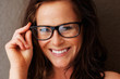 Closeup of a happy middle aged female wearing spectacle