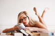 Woman in glasses reading novel