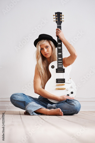 Photo: Young woman with a guitar Young woman with a guitar