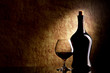 Cognac Glass and Bottle on a old stone background